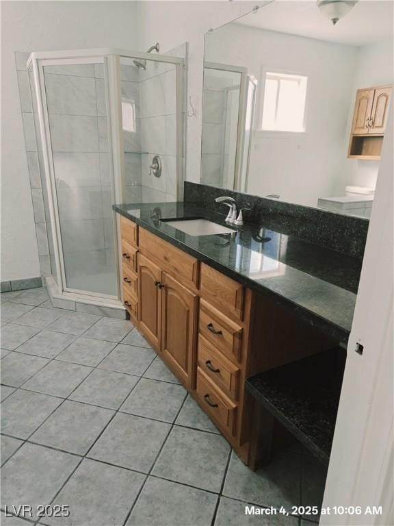 bathroom featuring a stall shower, tile patterned flooring, and vanity