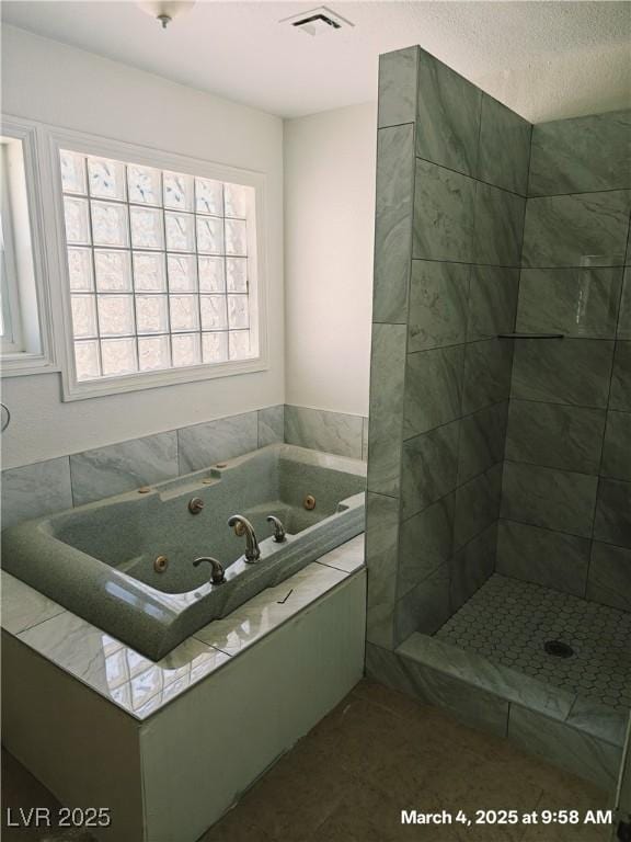 full bathroom with a jetted tub and visible vents