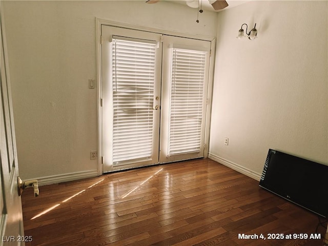 unfurnished room with ceiling fan, wood-type flooring, and baseboards