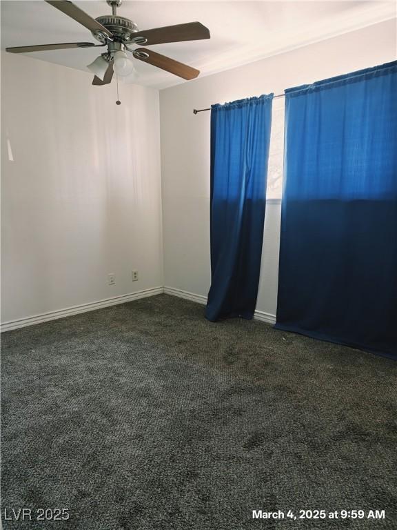 carpeted empty room with baseboards and a ceiling fan