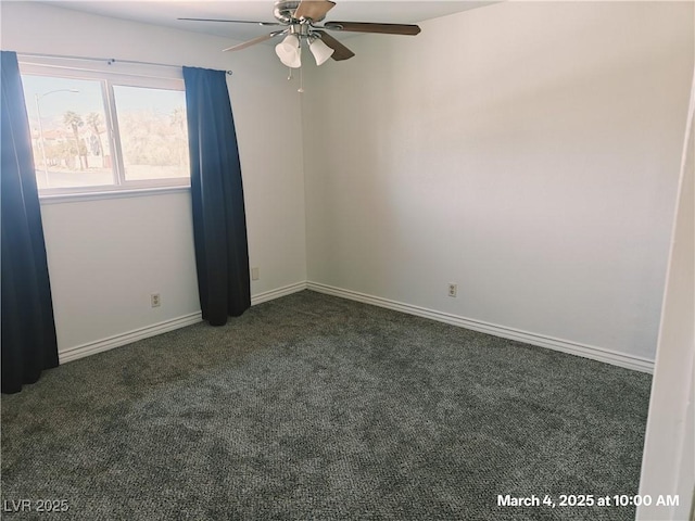 carpeted spare room featuring baseboards and a ceiling fan