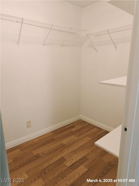 walk in closet featuring wood finished floors