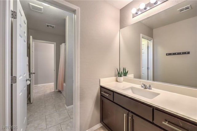 bathroom with tile patterned flooring, visible vents, and vanity