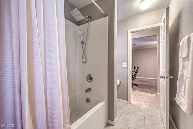 bathroom with tile patterned flooring, shower / tub combo with curtain, and baseboards