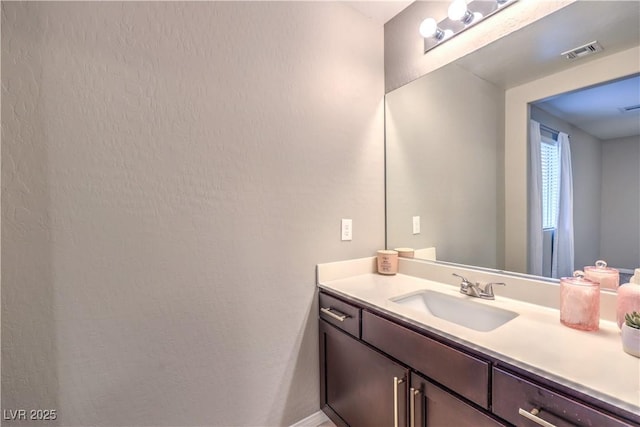 bathroom featuring visible vents and vanity