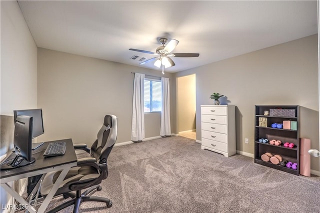 home office with a ceiling fan, carpet, visible vents, and baseboards