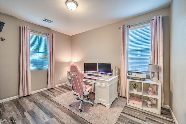 office space featuring visible vents, baseboards, and wood finished floors