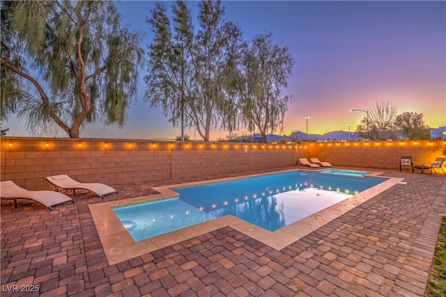 view of swimming pool with a fenced backyard, a fenced in pool, and a patio