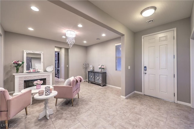 interior space with baseboards, a fireplace, visible vents, and recessed lighting