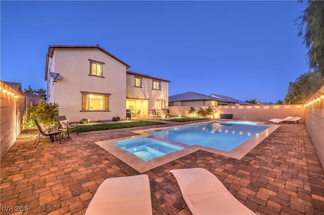 view of pool with a fenced in pool, a fenced backyard, a patio, and an in ground hot tub