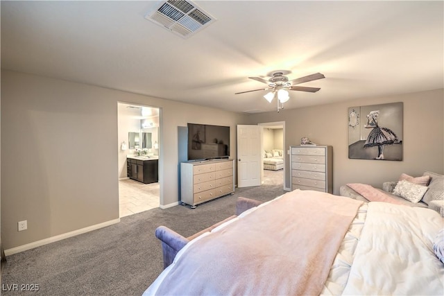 bedroom with baseboards, visible vents, a ceiling fan, ensuite bathroom, and carpet floors