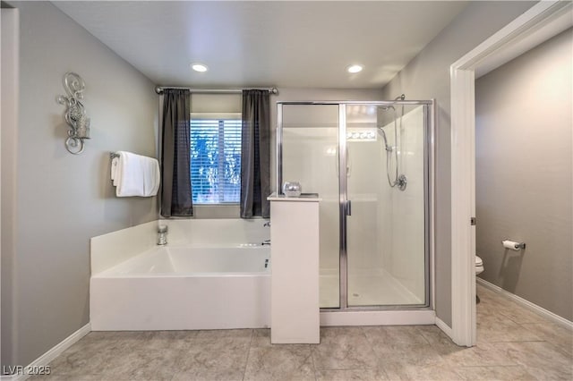 bathroom featuring baseboards, toilet, tile patterned floors, a garden tub, and a shower stall