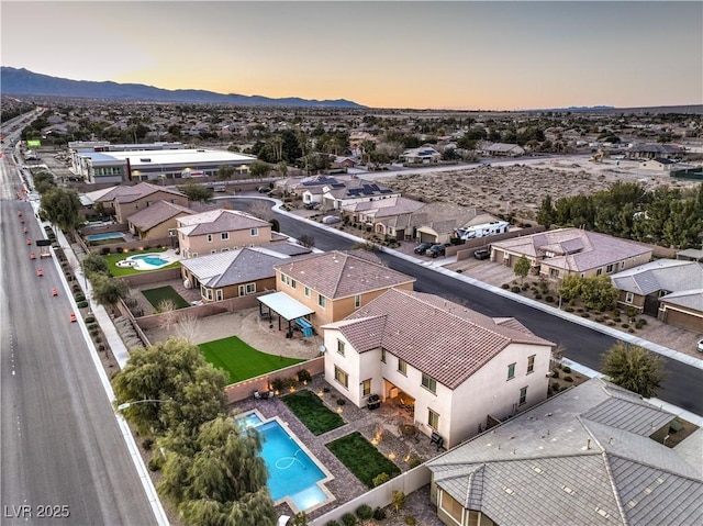 aerial view at dusk with a residential view and a mountain view