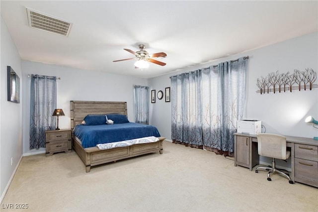 carpeted bedroom featuring ceiling fan, visible vents, and baseboards