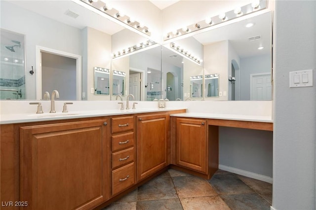 full bathroom featuring double vanity, a shower with door, visible vents, and a sink