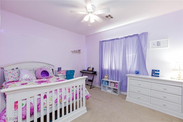 bedroom featuring ceiling fan, visible vents, and light colored carpet