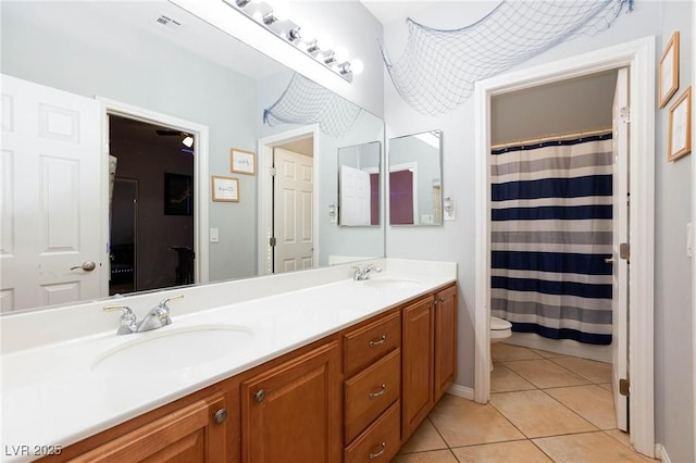 full bathroom with tile patterned flooring, a sink, toilet, and double vanity