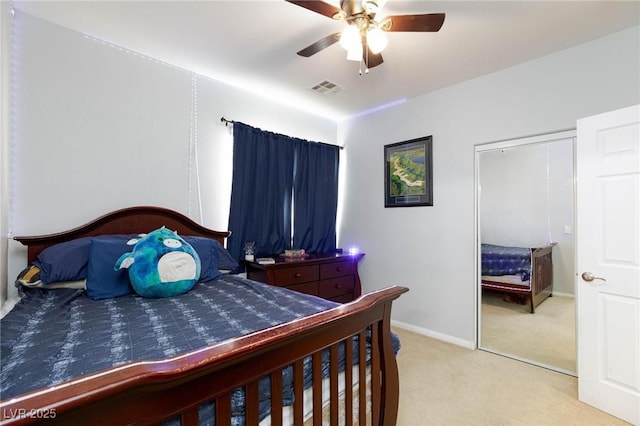 bedroom featuring baseboards, carpet floors, visible vents, and a ceiling fan