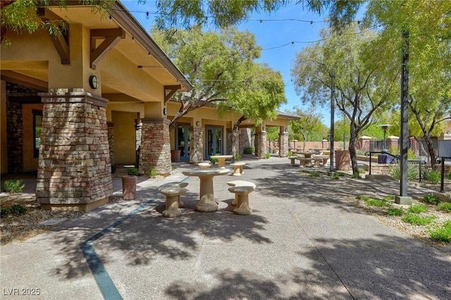 view of community with a patio area and fence