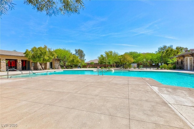 pool featuring a patio area and fence