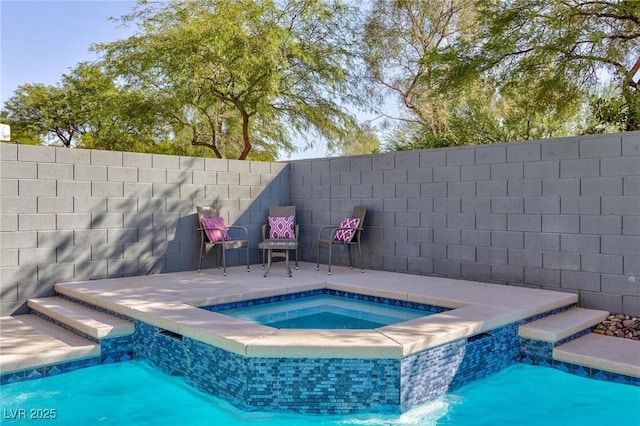 view of swimming pool featuring a fenced backyard and a pool with connected hot tub