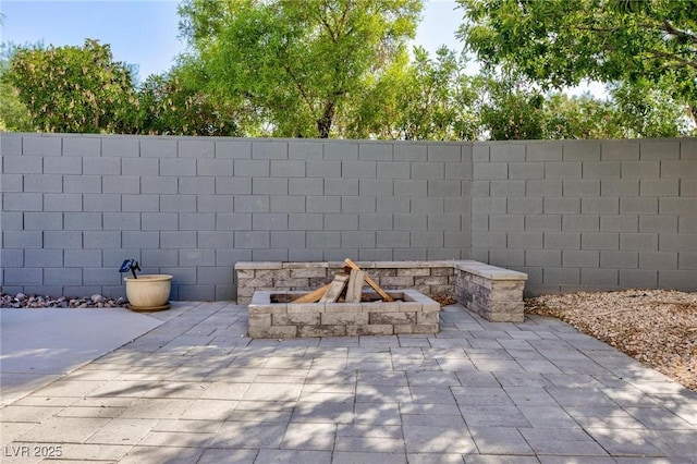 exterior details featuring fence and a fire pit