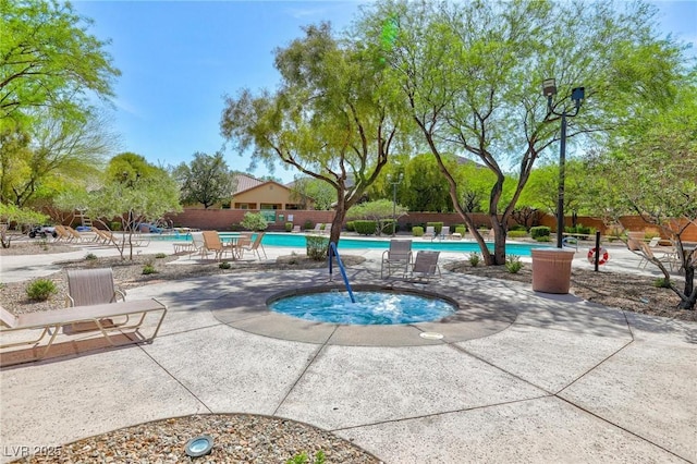 community pool with fence and a patio