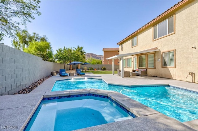 10288 Grizzly Forest Dr, Las Vegas, NV 89178 - view of pool featuring an outdoor living space, a pool with connected hot tub, a fenced backyard, a patio, and a mountain view