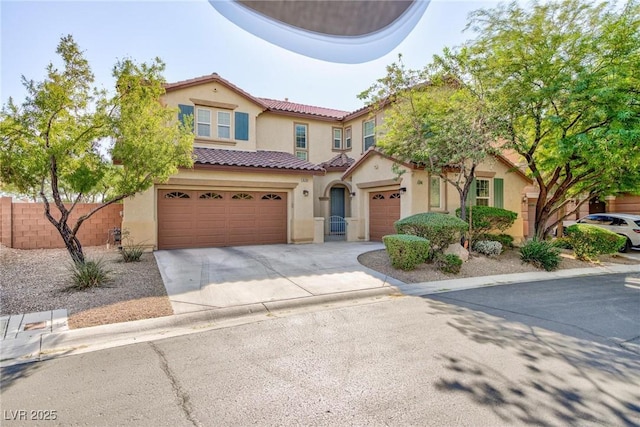 10288 Grizzly Forest Dr, Las Vegas, NV 89178 - mediterranean / spanish house with driveway, a tile roof, stucco siding, fence, and an attached garage