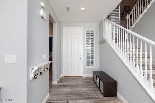 entryway with recessed lighting, wood finished floors, visible vents, baseboards, and stairs