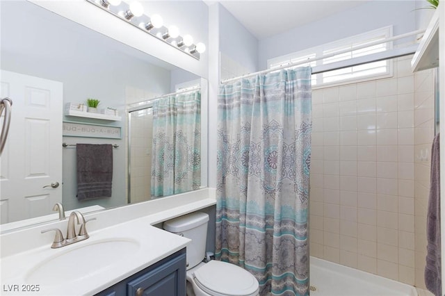 full bath featuring vanity, a tile shower, and toilet