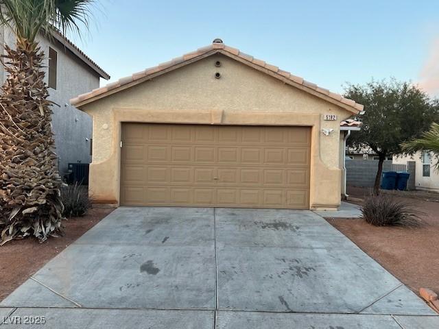 garage with concrete driveway