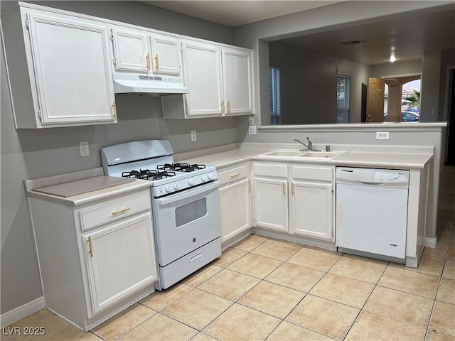 kitchen with light tile patterned floors, white cabinets, a sink, white appliances, and under cabinet range hood