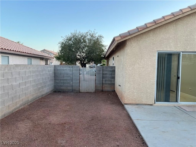 view of yard with a patio area, a gate, and fence