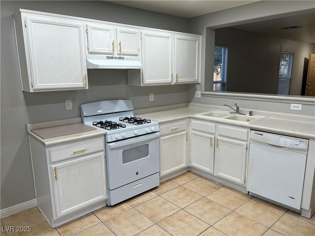 kitchen with white appliances, white cabinets, under cabinet range hood, a sink, and light tile patterned flooring