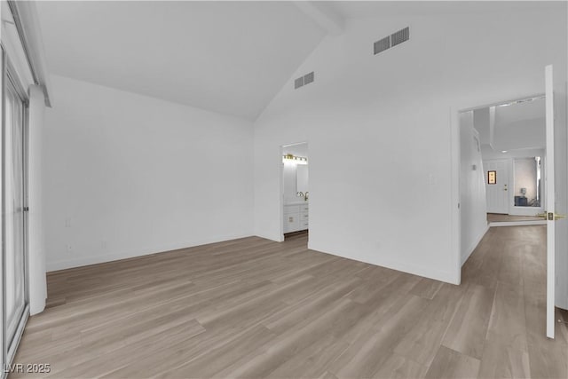 unfurnished bedroom with light wood-style floors, visible vents, beamed ceiling, and high vaulted ceiling