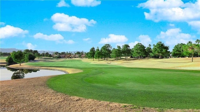 view of property's community featuring a water view, a lawn, and golf course view