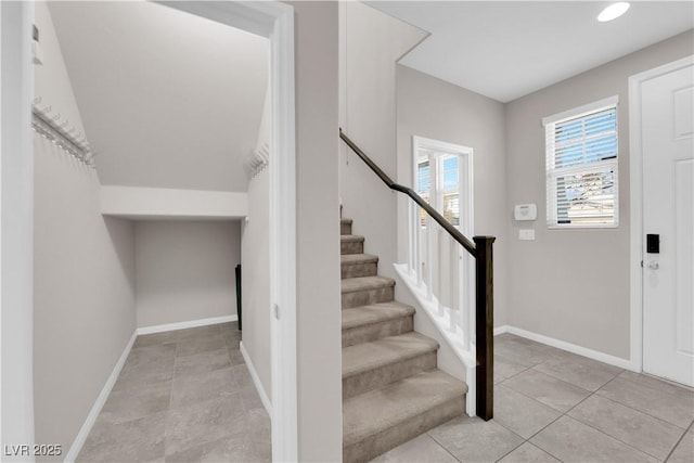 stairway with tile patterned flooring and baseboards