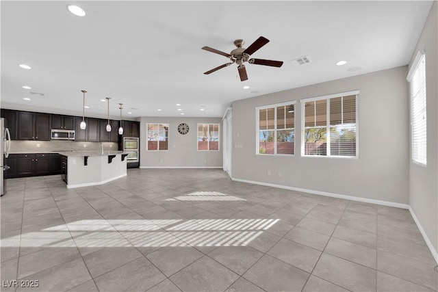 unfurnished living room with recessed lighting, light tile patterned flooring, visible vents, and baseboards