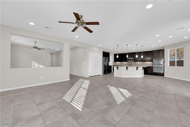 unfurnished living room featuring recessed lighting, visible vents, baseboards, and light tile patterned floors