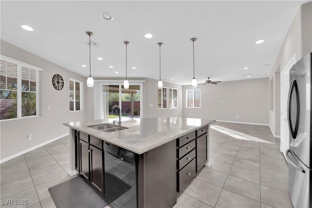 kitchen featuring dishwasher, freestanding refrigerator, light tile patterned flooring, a sink, and recessed lighting