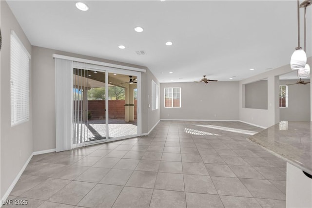 unfurnished living room featuring recessed lighting, ceiling fan, baseboards, and light tile patterned floors