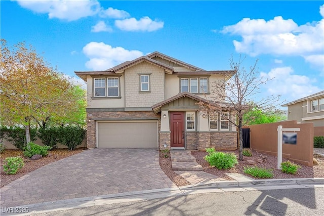 craftsman-style house featuring stone siding, decorative driveway, a garage, and stucco siding