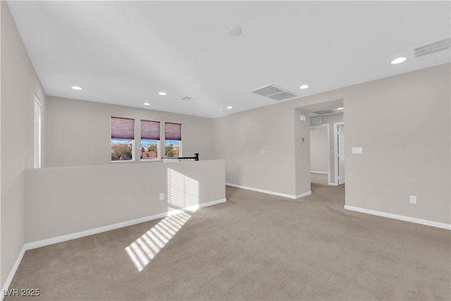 carpeted spare room with baseboards, visible vents, and recessed lighting