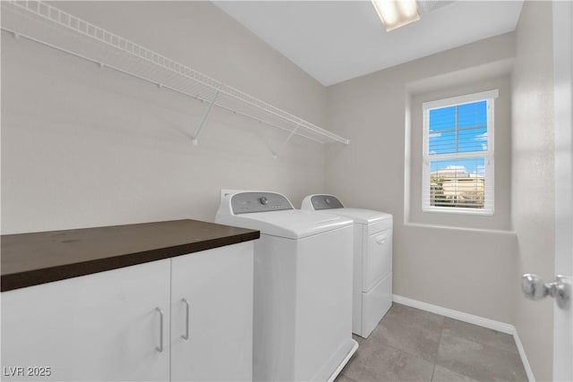 laundry area featuring separate washer and dryer and baseboards