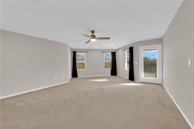 spare room with plenty of natural light, baseboards, and a ceiling fan