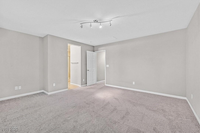 unfurnished bedroom featuring carpet, baseboards, and ensuite bathroom