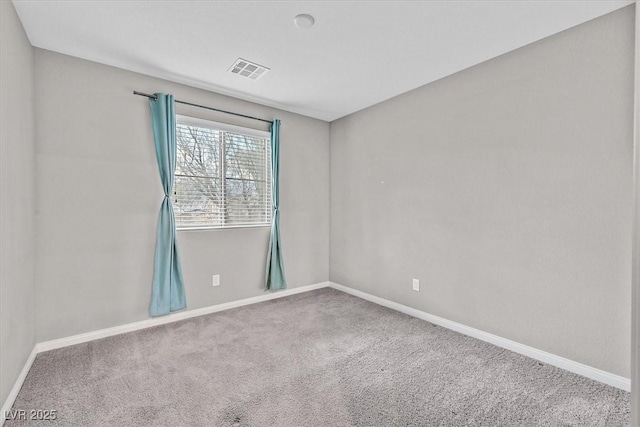 unfurnished room with baseboards, visible vents, and carpet flooring