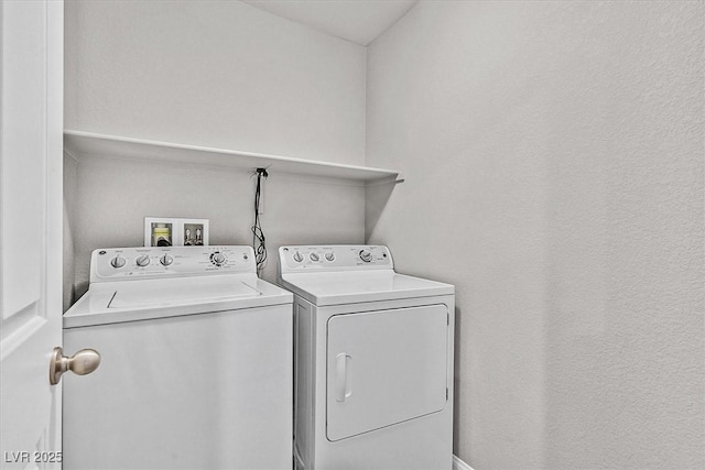 clothes washing area with laundry area and washer and clothes dryer