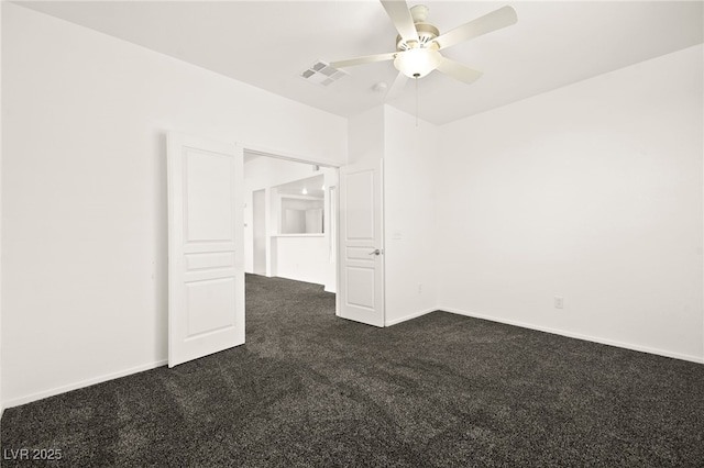 unfurnished room featuring visible vents, dark carpet, baseboards, and ceiling fan